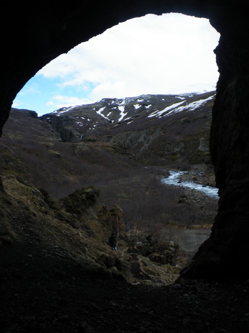 Viewing Glymur through a  cave inside a cliff-face on the trail. The daughter was thrilled to go cave exploring.